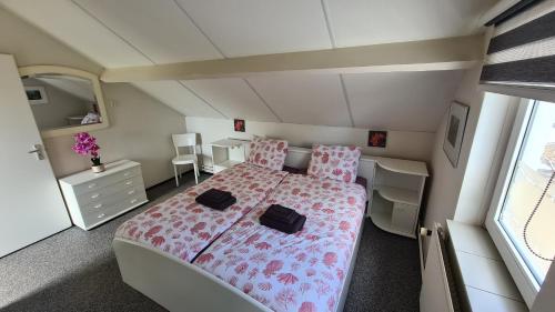 a small bedroom with a bed and a desk at Roos Guesthouse Holiday Appartements in Valkenburg