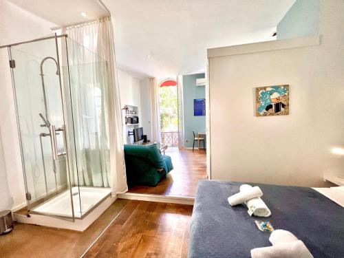 een badkamer met een douche en een bed in een kamer bij ApartHotel Riviera - Grimaldi Coeur de Ville - Large Studio AC with bigger South Terrace - Hyper Centre - 5mn plage- TERRASSE ESPRIT in Nice
