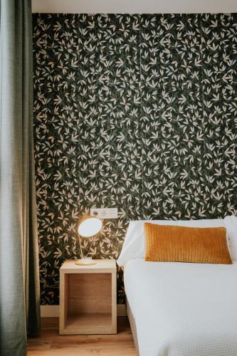 a bedroom with a bed and a black and white wallpaper at Rincon 13 - Mares in Torre del Mar