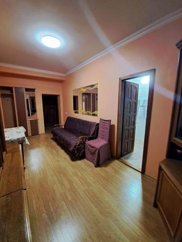 a living room with a couch and a chair at Zatyshok in Chernivtsi