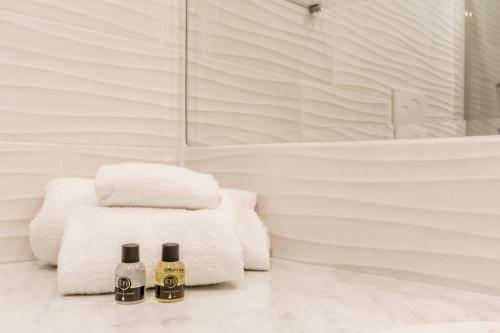 two bottles of champagne sitting on a counter in a bathroom at Frezza's Holidays in Rome