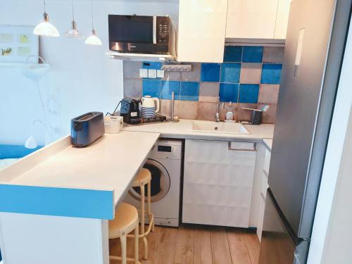 a small kitchen with a sink and a dishwasher at Appartement Marina magnifique vue in Deauville