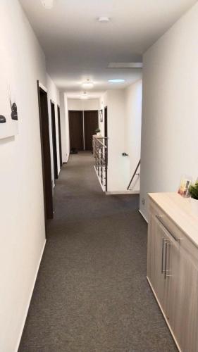 a hallway of an office with white walls and a staircase at PENZION U BRÁZDŮ in Ivančice