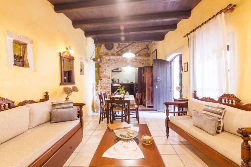 a living room with a couch and a table at Samonas - 5 maisonettes with breathtaking views in Chania Town