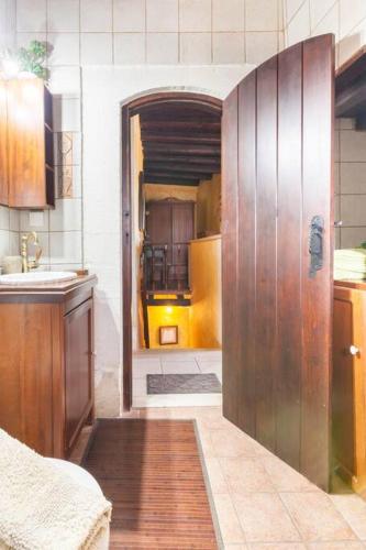 a kitchen with a large wooden door in a room at Samonas - 5 maisonettes with breathtaking views in Chania Town