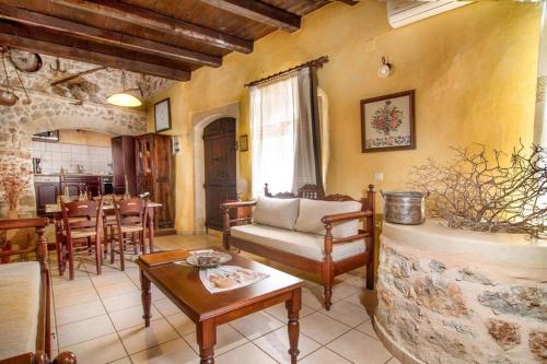 a living room with a couch and a table at Samonas - 5 maisonettes with breathtaking views in Chania Town
