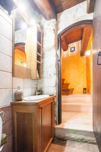 a bathroom with a sink and a shower at Samonas - 5 maisonettes with breathtaking views in Chania Town