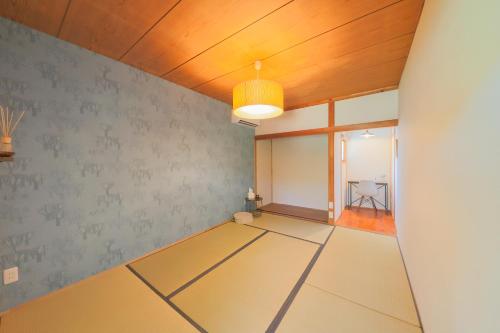 an empty room with a ping pong table at guesthouse minkä in Amami
