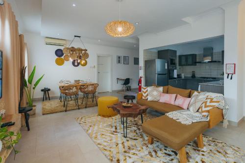 a living room with a couch and a table at The Avery Apartments, Dzorwulu in Accra