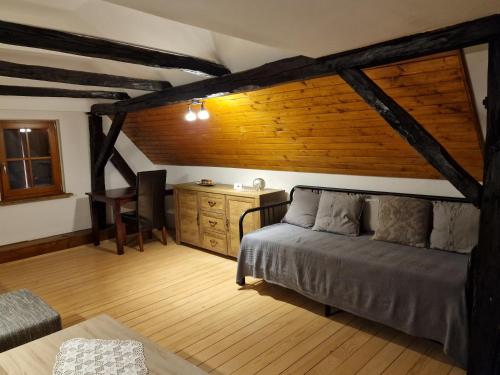 a bedroom with a bed and a desk in a room at Vacation House Donacka Gora in Rogatec
