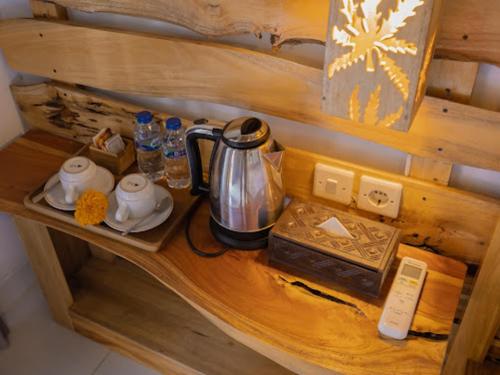 a wooden shelf with a tea kettle on it at KUBU YANG COTTAGE in Nusa Penida