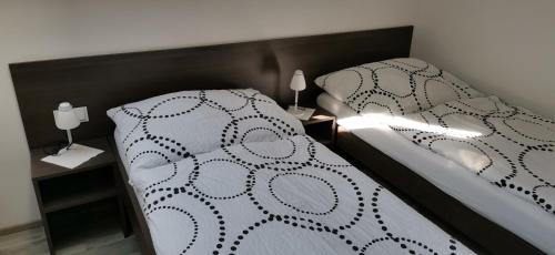 a model of a bedroom with a bed and two lamps at PENZION U BRÁZDŮ in Ivančice