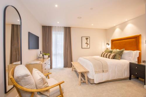 a bedroom with a bed and a desk and a chair at Apartment 21 Hudson Quarter Luxury Apartments-Free parking 1 car in York
