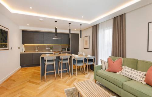 a living room with a couch and a kitchen at Apartment 21 Hudson Quarter Luxury Apartments-Free parking 1 car in York