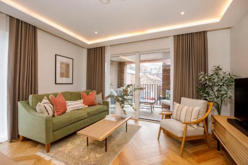 a living room with a green couch and a table at Apartment 21 Hudson Quarter Luxury Apartments-Free parking 1 car in York