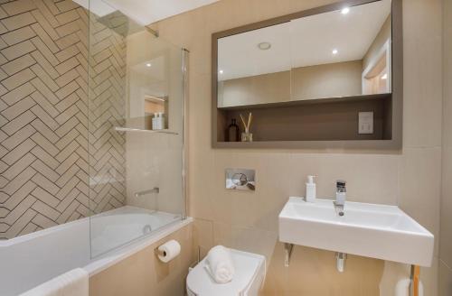 a bathroom with a white sink and a toilet at Apartment 21 Hudson Quarter Luxury Apartments-Free parking 1 car in York