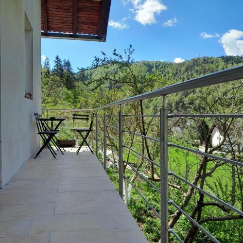 a balcony of a house with a view of the forest at Nice Apartment near by Capital of Slovenia in Ljubljana