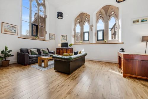 a living room with two couches and a piano at Host & Stay - Belvidere Church in Liverpool