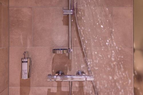 a shower with a hose and a shower head at Boutique Hotel Pellas in Vella