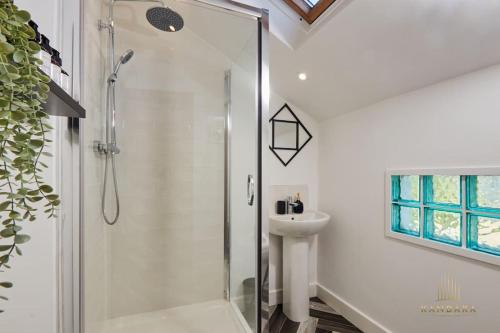 a white bathroom with a shower and a sink at Stunning 5Bed All En-suite Headingley Home in Headingley