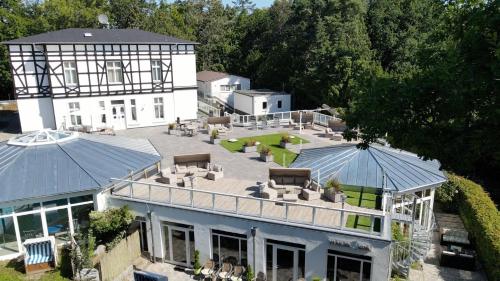 an aerial view of a white house with a patio at Best Western Plus Ostseehotel Waldschloesschen in Prerow