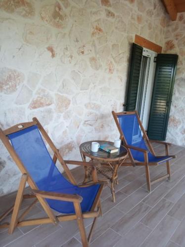 two chairs and a table on a patio at Olive Trees in Tragaki
