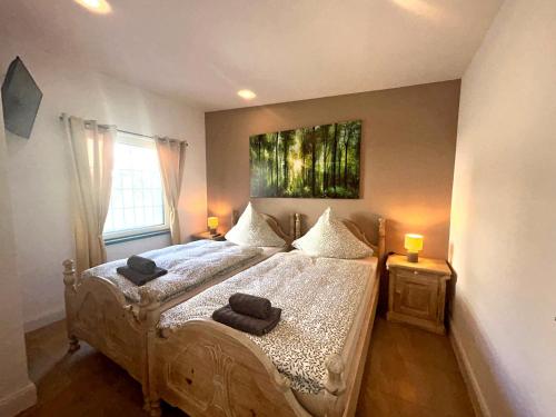 a bedroom with a bed and a painting on the wall at Landhaus Stedtfeld in Stedtfeld