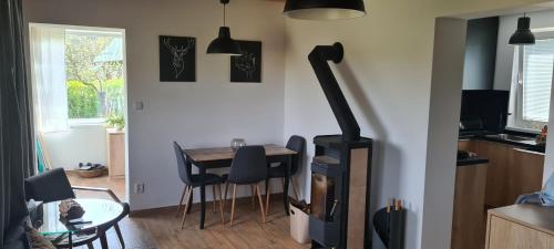 a kitchen with a table and a stove in a room at Chata Pinie in Ivančice