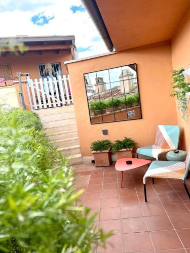 a patio with chairs and a table and a window at Navona 49 Luxury Suites&Apartment in Rome
