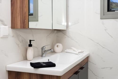 a bathroom counter with a sink and a mirror at D & G apartment in Kariá