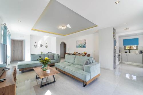 a living room with two blue couches and a table at D & G apartment in Kariá