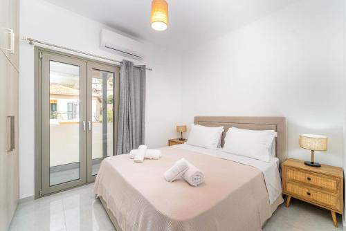 a bedroom with a bed with towels on it at D & G apartment in Kariá
