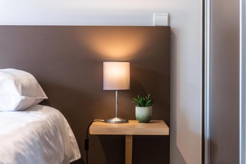 Postel nebo postele na pokoji v ubytování Belcasa Suitehotel