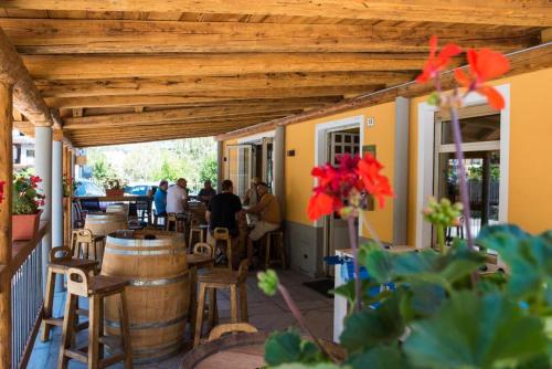 an outdoor patio with barrels and a wooden pergola at La Maison in Aymavilles