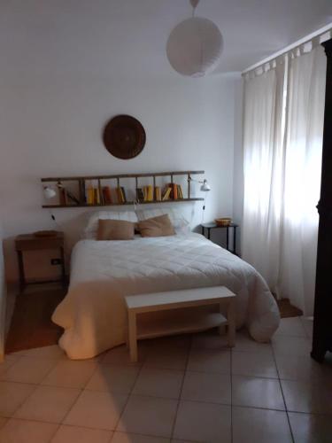 a bedroom with a bed with a bench on it at STARE BENE B&B in Bernezzo