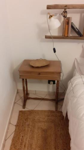 a table with a lamp on it next to a bed at STARE BENE B&B in Bernezzo
