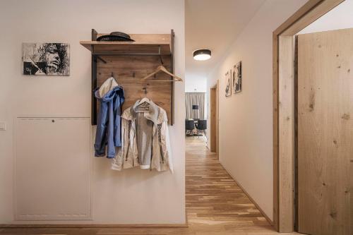 a hallway with a coat rack and a door at monas home mayrhofen in Mayrhofen