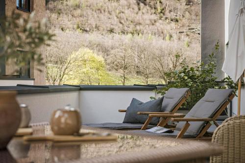 a patio with two chairs and a table on a balcony at monas home mayrhofen in Mayrhofen