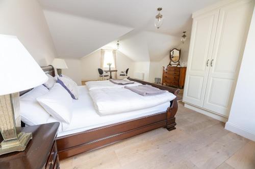 a bedroom with a large bed with white sheets at Screebe House in Rosmuck