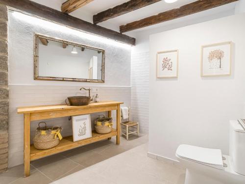 a bathroom with a mirror and a sink at Cal Rellotger de Solsona in Solsona
