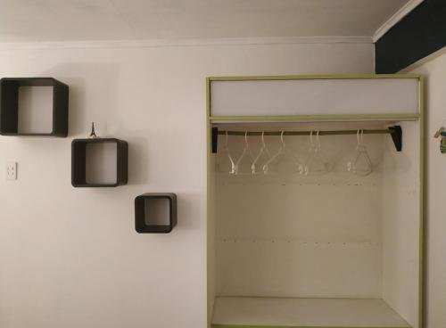 a room with a closet with wine glasses in it at VidaNatural in Santiago