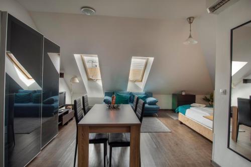 a living room with a table and a room with a bed at Mango Apartments in Budapest