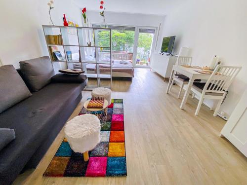 a living room with a couch and a table at Little Black Forest Garden in Pforzheim