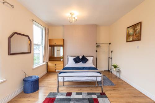 a bedroom with a bed and a mirror at Captivating 5-Bed House in Liverpool with parking in Liverpool