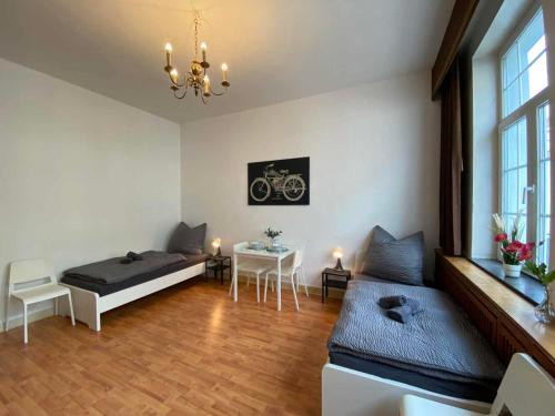 a living room with a bed and a table at Apartment with balcony in Lengerich in Lengerich