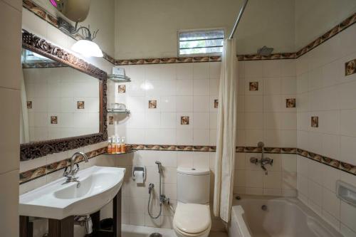 a bathroom with a sink and a toilet and a tub at Hotel Narain Niwas Palace in Jaipur