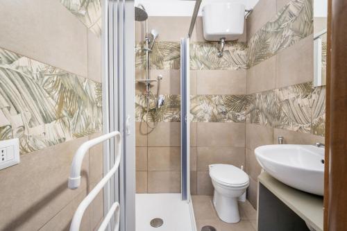a bathroom with a shower and a toilet and a sink at Rooms Piramide in Rome