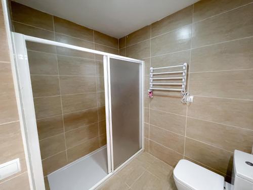 a shower with a glass door in a bathroom at Turquesa & Ambar Apartments Formentera in La Savina