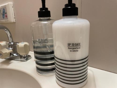 two bottles of water sitting on a bathroom sink at Best Shinjuku Modern Full-furnished Family size Apartment4 ONLY 2min to Shinjuku by Train in Tokyo