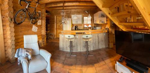 a living room with a bar in a log cabin at Blockhaus Rennsteig in Neuhaus am Rennweg